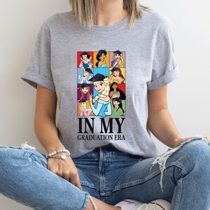 a woman sitting on the floor wearing a t - shirt that says in my graduation