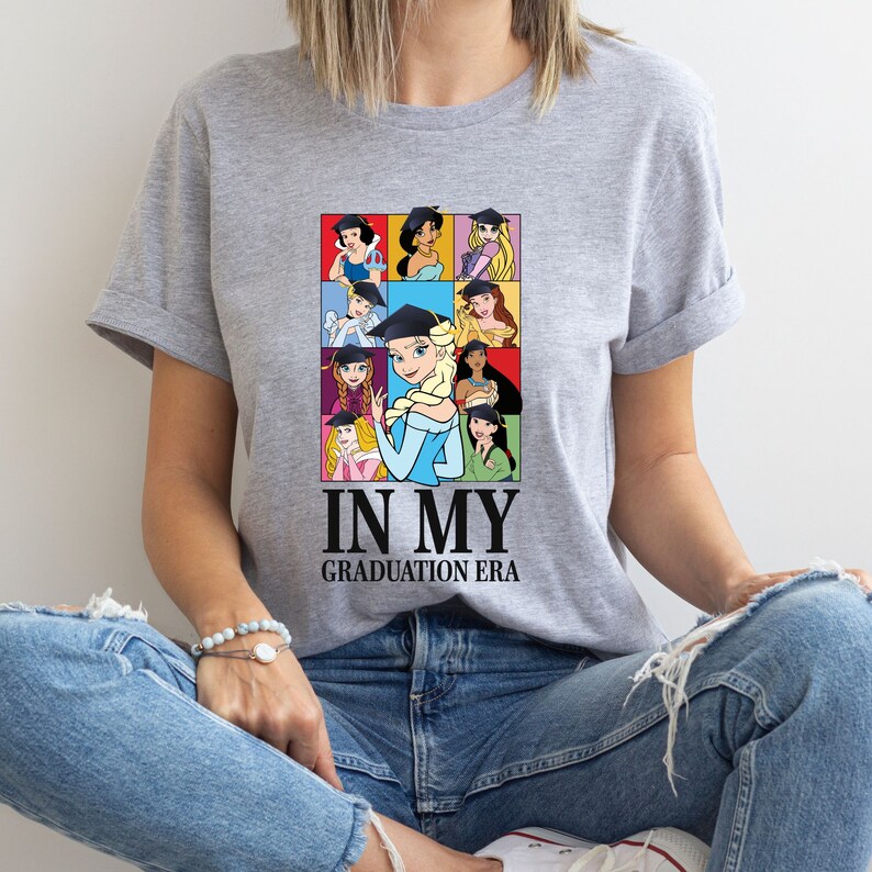 a woman sitting on the floor wearing a t - shirt that says in my graduation
