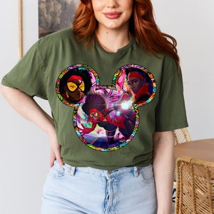 a woman with red hair wearing a mickey mouse t - shirt
