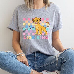 a woman wearing a t - shirt with the lion king on it