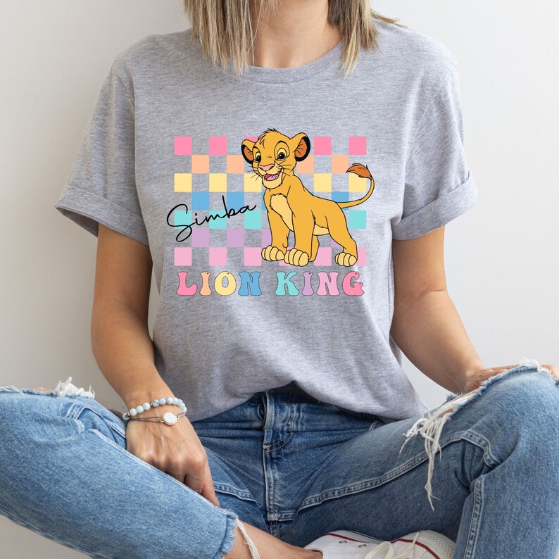 a woman wearing a t - shirt with the lion king on it