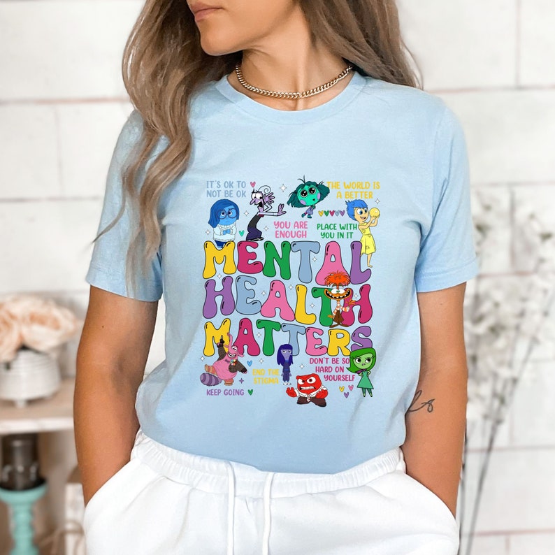a woman wearing a blue shirt with the words mental health matters printed on it