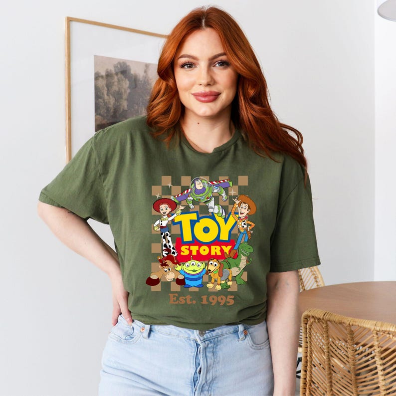 a woman with red hair wearing a toy story t - shirt