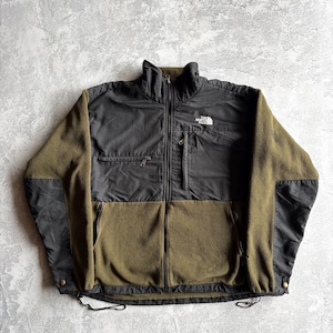 May include: A white ceramic mug with a black handle and the text "But First, Coffee" in a bold, black font. The mug is set against a neutral background, highlighting its simple design.