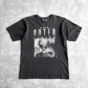 May include: Dark gray t-shirt featuring the text "THE OUTER LIMITS" above a black and white image of an alien-like figure. The shirt has short sleeves and a crew neck.