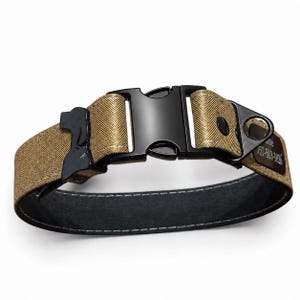 May include: A tan nylon pet collar featuring a black plastic side-release buckle, a black metal D-ring, and a black dog-shaped attachment. The collar includes a black metal identification tag with engraved text reading 757-503-1820.