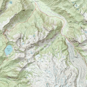 May include: A topographic map of Mount Rainier National Park in Washington state. The map shows trails, lakes, rivers, and elevation contours. A red dashed line indicates a hiking trail.