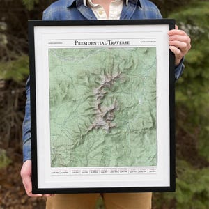 May include: A framed map of the Presidential Traverse in the White Mountains of New Hampshire. The map shows the terrain with elevation lines and labels for the different peaks and trails.