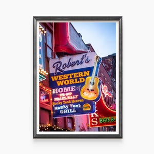 May include: A neon sign for Robert's Western World, a honky tonk bar in Nashville, Tennessee. The sign features a red boot, a guitar, and the text "Robert's Western World, Home of the B.B. King Praxitely, Honky Tonk Heaven, Honky Tonk Grill".