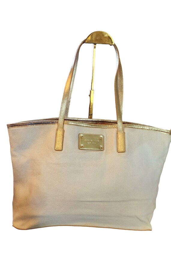 Michael Kors cream colored with gold leather trim 