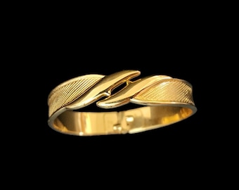 Vintage Monet hinged cuff gold tone bracelet.