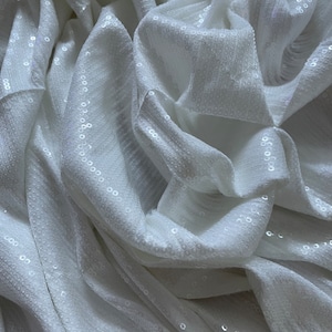 Flexible White and Silver Sequined Fabric with two color options... It is flexible and does not require lining...