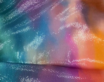 May include: A close-up of iridescent fabric with a tie-dye pattern in shades of blue, purple, orange, and yellow.