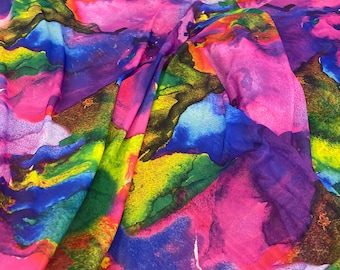 May include: Abstract watercolor print fabric in shades of pink, blue, green, and yellow. The fabric has a flowing, organic pattern.