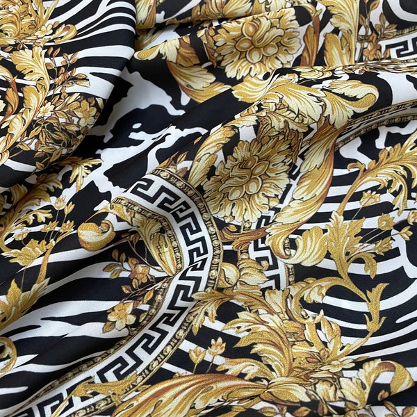 Tessuto crêpe setoso con motivo zebrato e barocco, tessuto di alta qualità, tessuto oro nero-ala