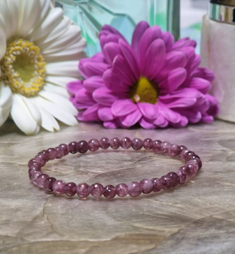 May include: A purple gemstone bracelet with small, round beads. The bracelet is made of natural stones and is a beautiful accessory for any occasion.