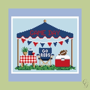 May include: A pixel art cross stitch pattern featuring a blue canopy tent with the text GAME DAY, red and blue bunting, a table with a red and white checkered cloth, a blue folding chair with GO REBS text, and a red cooler with a football.