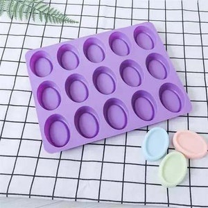 May include: Purple silicone mold with 16 oval-shaped cavities for making soap or other crafts.
