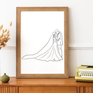 May include: A black and white line drawing of a bride and groom kissing, framed in a light wood frame.