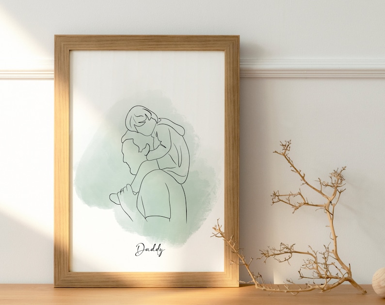 May include: A framed line art print of a father and child. The child is sitting on the father's shoulders. The print has a green watercolor background and the word "Daddy" is written at the bottom.