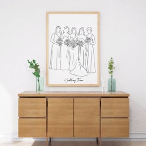 May include: A black and white line drawing of five women in dresses, holding bouquets. The bride is in the centre, and the bridesmaids are on either side of her. The text "Wedding Team" is written below the drawing.