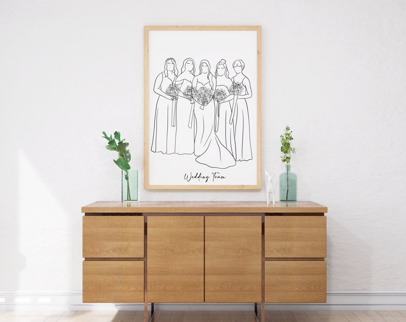 May include: A black and white line drawing of five women in dresses, holding bouquets. The bride is in the centre, and the bridesmaids are on either side of her. The text "Wedding Team" is written below the drawing.
