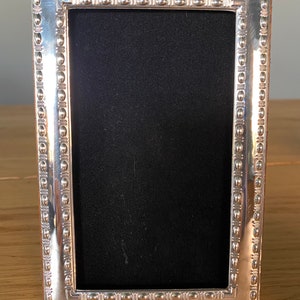 Sterling 925 Silver Photograph Frame. Photo size 5”x3”. Contemporary beaded style. Fully Hallmarked in London including date. Velvet back.