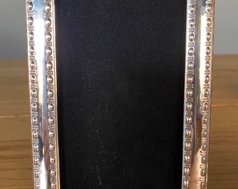 Solid Silver Photograph Frame. Photo size 5”x3”. Contemporary beaded style. Fully Hallmarked in London including date. Velvet back.