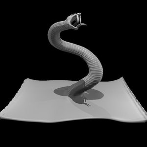 May include: A gray, 3D printed model of a snake with its head raised and mouth open, as if it is about to strike. The snake is on a gray, flat surface.