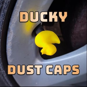 May include: Yellow rubber ducky shaped tyre valve stem dust caps. The caps say "DUCKY DUST CAPS" in orange text.