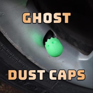 May include: Green glow-in-the-dark tyre valve stem caps with a ghost design. The caps are labelled "Ghost Dust Caps".