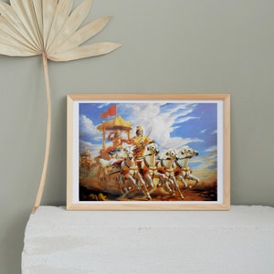 May include: A framed print of a painting depicting a chariot pulled by six white horses. The chariot is driven by a man wearing a golden crown and holding a whip. The chariot is surrounded by clouds and a blue sky.