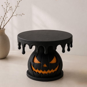 May include: A black cake stand featuring a pumpkin base with orange cutouts for eyes and a mouth, topped with a circular platform with a melting drip design. The text HALLOWEEN MELTING CAKE STAND and 3D STL -MF MODEL is visible at the top.