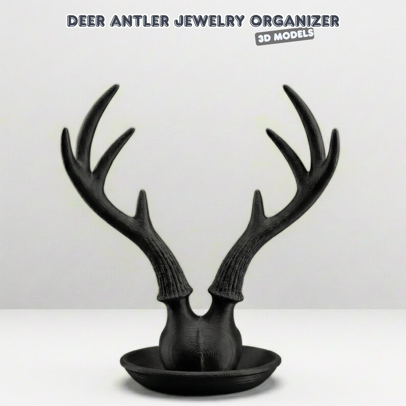 May include: A black deer antler jewelry organizer with a round base. The antlers are stylized and extend upwards. The text "DEER ANTLER JEWELRY ORGANIZER" and "3D MODELS" are at the top of the image.