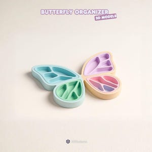 Puede incluir: Un organizador con forma de mariposa con compartimentos en colores pastel: azul claro, verde, rosa y morado. El texto "BUTTERFLY ORGANIZER" y "3D MODELS" se muestran arriba. El organizador está diseñado para objetos pequeños.