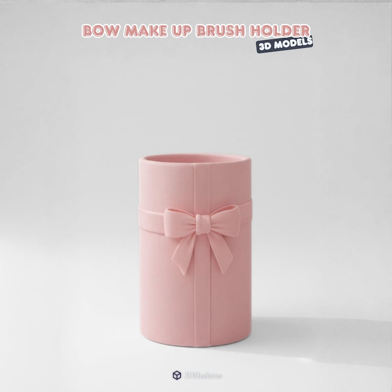May include: A pink cylindrical makeup brush holder with a bow and ribbon design. The text "BOW MAKE UP BRUSH HOLDER" is at the top of the image, with "3D MODELS" below it. The holder is a solid color and has a matte finish.