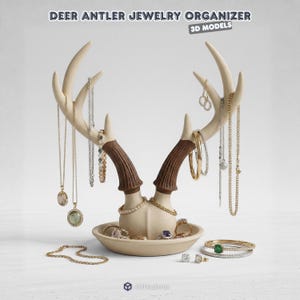 Puede incluir: Un organizador de joyas con forma de cuerno de ciervo de color crema con detalles en marrón. El organizador contiene collares, pendientes, anillos y pulseras. El texto "DEER ANTLER JEWELRY ORGANIZER" está en la parte superior.