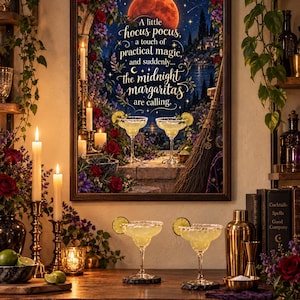 May include: A framed wall art print featuring a night scene with a large red moon, flowers, candles, a broom, and two margaritas. The text reads: A little hocus pocus, a touch of practical magic, and suddenly... the midnight margaritas are calling.