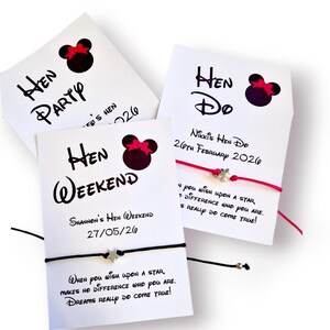 May include: Three white cards with black text and a Minnie Mouse silhouette with a pink bow. The cards read "Hen Party", "Hen Weekend", and "Hen Do". Each card has a bracelet attached.