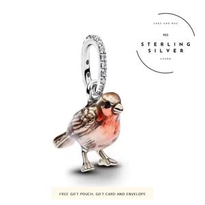 May include: A sterling silver charm shaped like a robin bird with a red breast and brown wings, featuring a bail encrusted with small clear stones. The text CHEZ AND MAZ 925 STERLING SILVER CHARM is visible in the upper right corner.