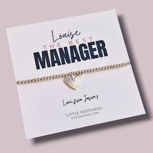May include: A silver beaded bracelet with a heart charm is presented on a white card. The card features the text "Louise The Best Manager" in black and the words "Love from Jason x" in cursive.