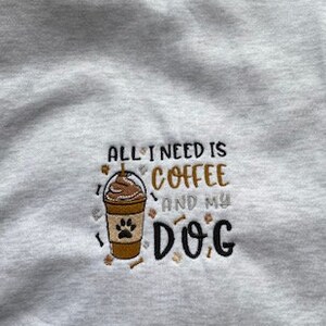 Grey hoodie with All I need is coffee and my dog emblem.