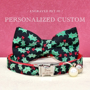 May include: A personalized pet collar and bow tie set. The collar and bow tie feature a black background with a green holly and red berry pattern. The collar has a silver buckle engraved with a name and phone number. The text "/ ENGRAVED PET ID / PERSONALIZED CUSTOM" is above the collar.