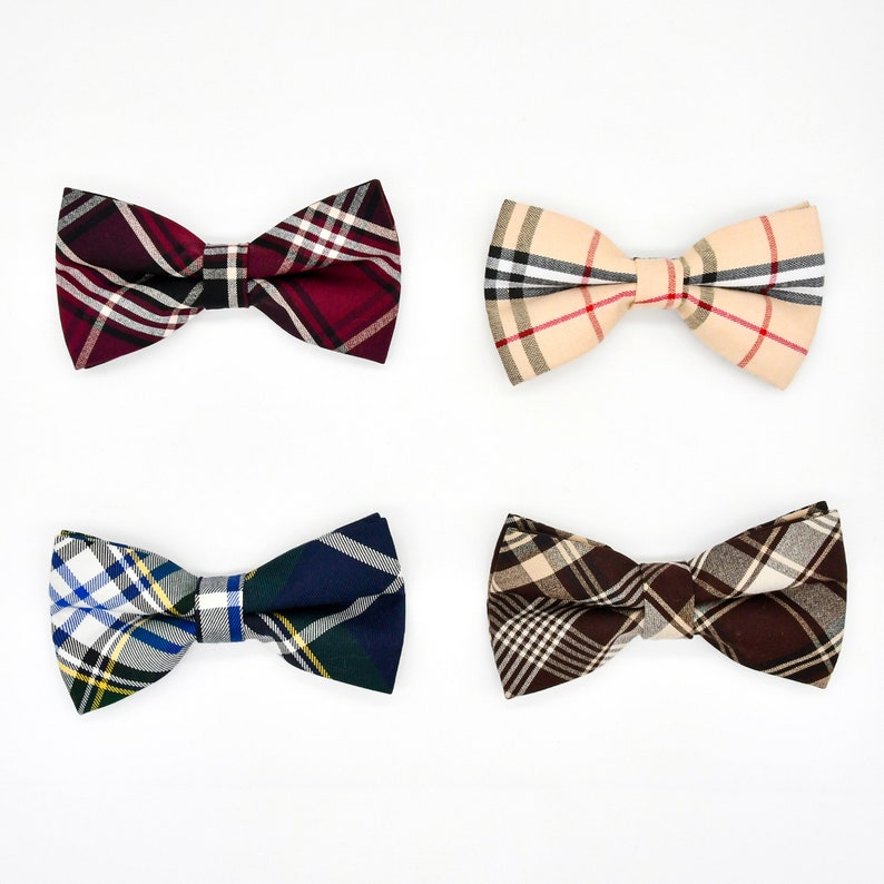 May include: Four bow ties in different plaid patterns: red and black, beige and brown, blue and yellow, and brown and beige.