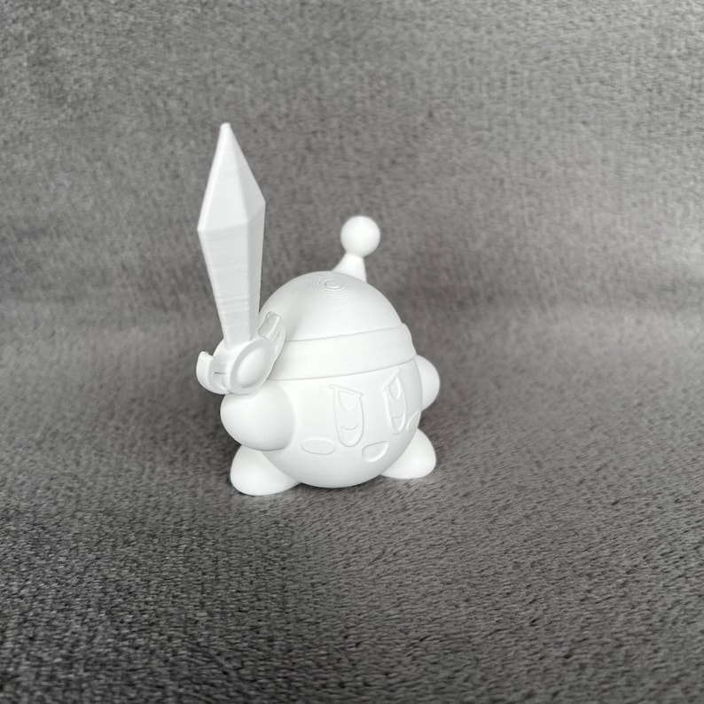 May include: A white 3D printed figurine of a pink character with a sword, wearing a helmet and holding a sword. The character has a round body and a smiling face.