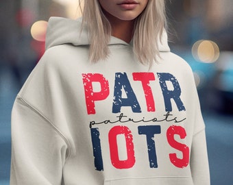 May include: A white hoodie with a red, white, and blue graphic that says "PATRIOTS" with the word "patriots" written in smaller letters underneath.