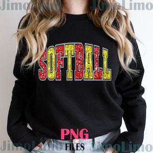 May include: A black sweatshirt with the word "SOFTBALL" in red and yellow glitter letters. The letters have a gray outline.