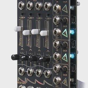 May include: Black electronic music synthesizer module labelled "RICOCHET" and "Quad chained analog decay/VCA". It has multiple knobs, jacks, and sliders, with "Decay" printed on the sliders. The module includes a series of LED lights.