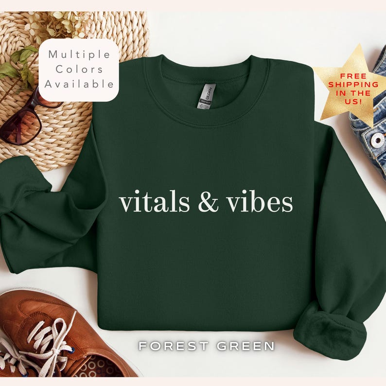 May include: Forest green sweatshirt with the text "vitals & vibes" in white lettering.