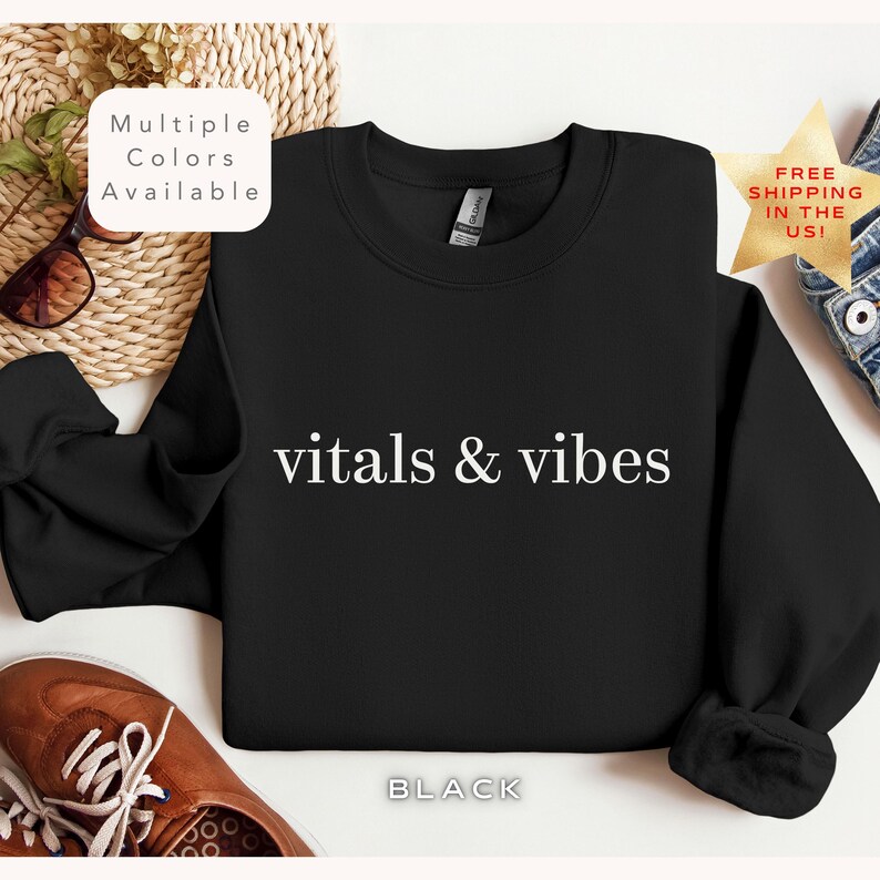 May include: Black sweatshirt with white text that reads "vitals & vibes".